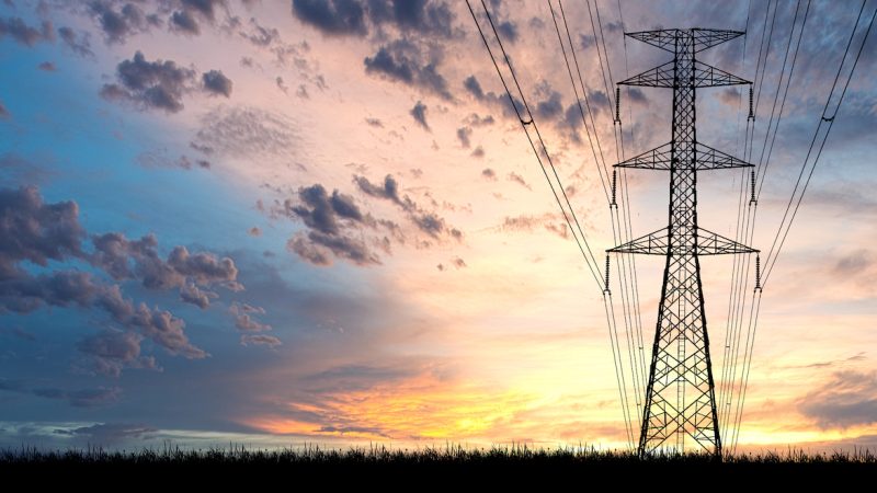 High voltage power transmission towers Have a complex steel structure In the evening. high-voltage power lines at sunset,high voltage electric transmission tower
