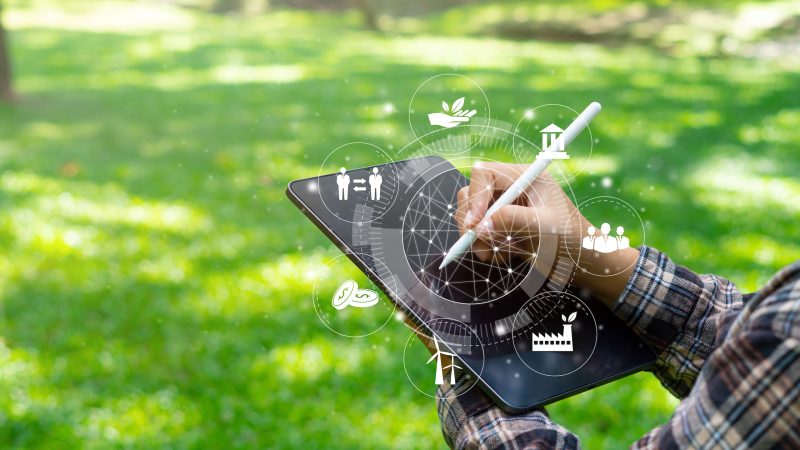 explorer at ipad communication tool ready to study Renewable resources to reduce pollution In concept ESG icons in hand for environmental, social and sustainable business governance.